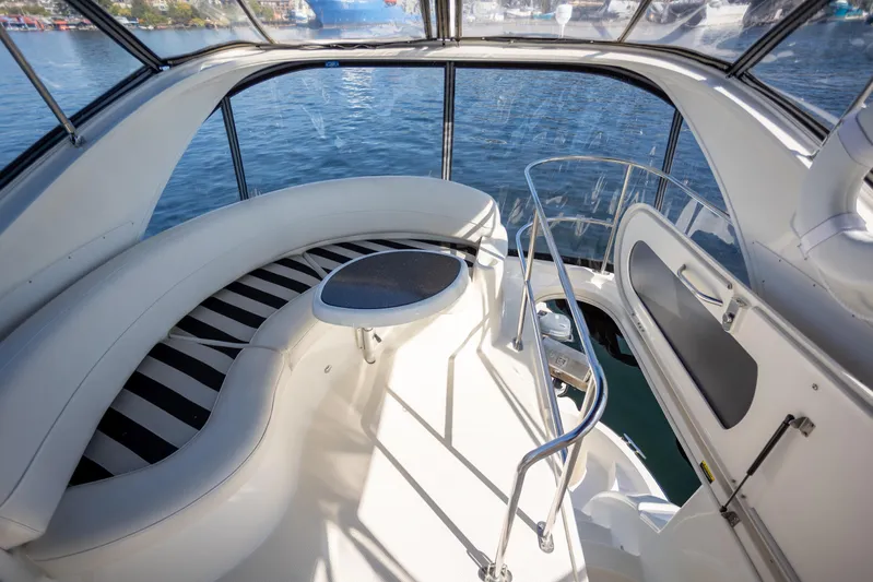 Seacougs Yacht Photos Pics Interior view of 2008 Meridian 341 Sedan yacht with curved seating and water backdrop.