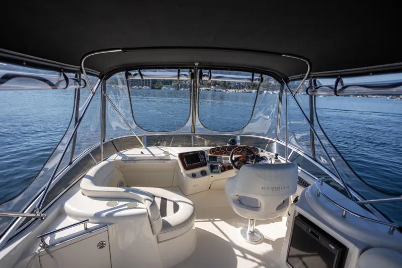 Seacougs Yacht Photos Pics Interior view of 2008 Meridian 341 Sedan yacht cockpit with steering wheel and seating.