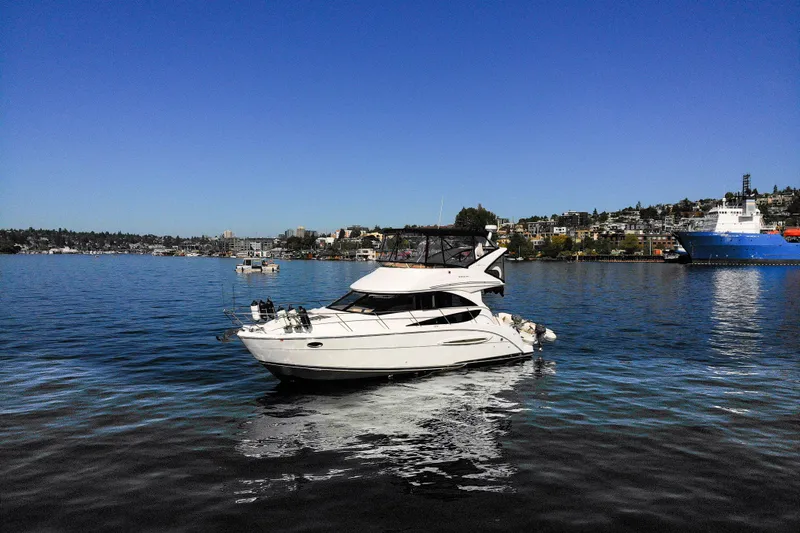 Seacougs Yacht Photos Pics 2008 Meridian 341 Sedan yacht cruising on a sunny day in a scenic harbor.