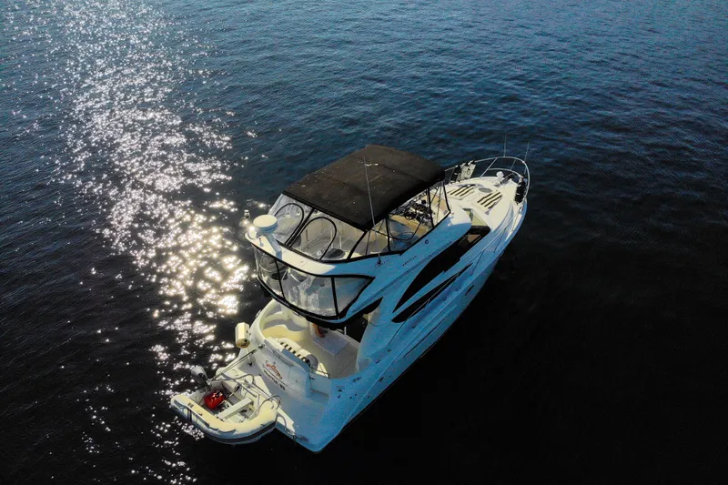 Seacougs Yacht Photos Pics 2008 Meridian 341 Sedan yacht on calm water with sun reflections.