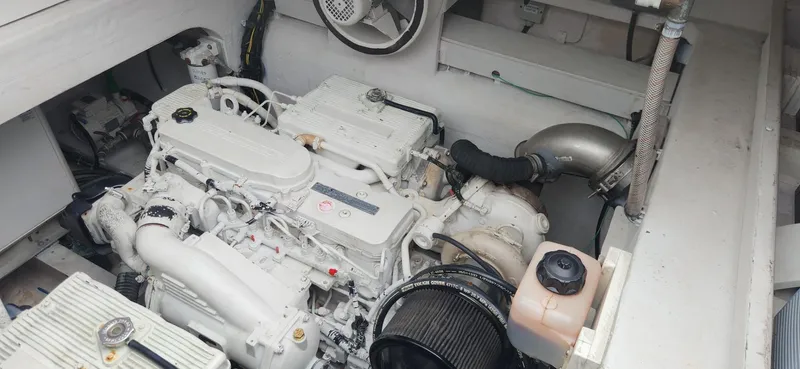 Catch And Release Yacht Photos Pics Engine compartment of a 2017 Trident Custom boat, showcasing a clean, white engine setup.