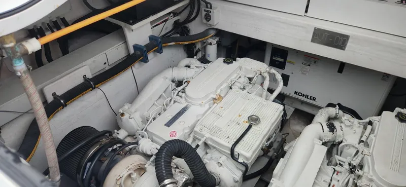 Catch And Release Yacht Photos Pics Engine room of a 2017 Trident Custom boat with Kohler generator and white machinery.