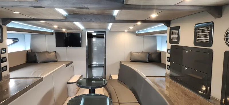 Catch And Release Yacht Photos Pics Luxurious interior of a 2017 Trident Custom boat with modern seating and entertainment area.