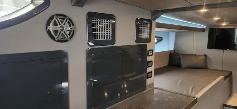 Catch And Release Yacht Photos Pics Interior of 2017 Trident Custom boat with modern design, speaker, and cozy sleeping area.
