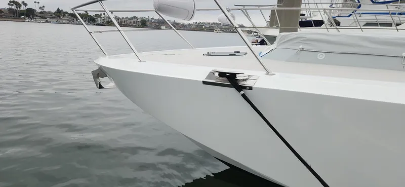 Catch And Release Yacht Photos Pics 2017 Trident Custom boat docked in a marina, featuring sleek white hull and stainless steel railings.