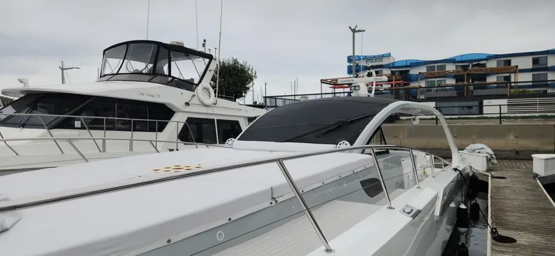 Catch And Release Yacht Photos Pics 2017 Trident Custom yacht docked at marina, featuring sleek design and modern architecture in background.