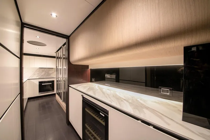 Nirvana By The Sea Yacht Photos Pics Luxurious kitchen interior of 2019 Azimut Grande 27 METRI yacht, featuring modern design and sleek finishes.