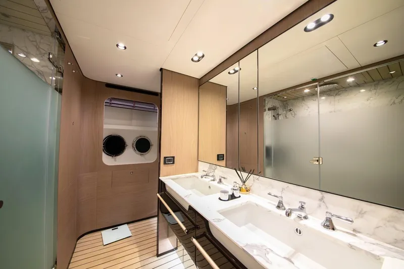 Nirvana By The Sea Yacht Photos Pics Luxurious bathroom interior of 2019 Azimut Grande 27 METRI yacht with dual sinks and modern design.