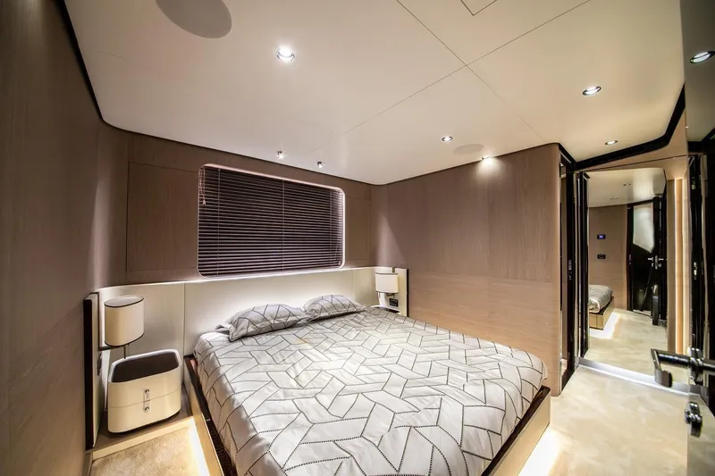 Nirvana By The Sea Yacht Photos Pics Luxurious bedroom interior of 2019 Azimut Grande 27 METRI yacht, featuring modern design and ambient lighting.