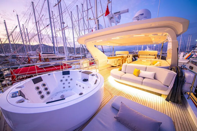 Nirvana By The Sea Yacht Photos Pics Luxurious 2019 Azimut Grande 27 METRI yacht deck with jacuzzi and elegant seating at sunset.