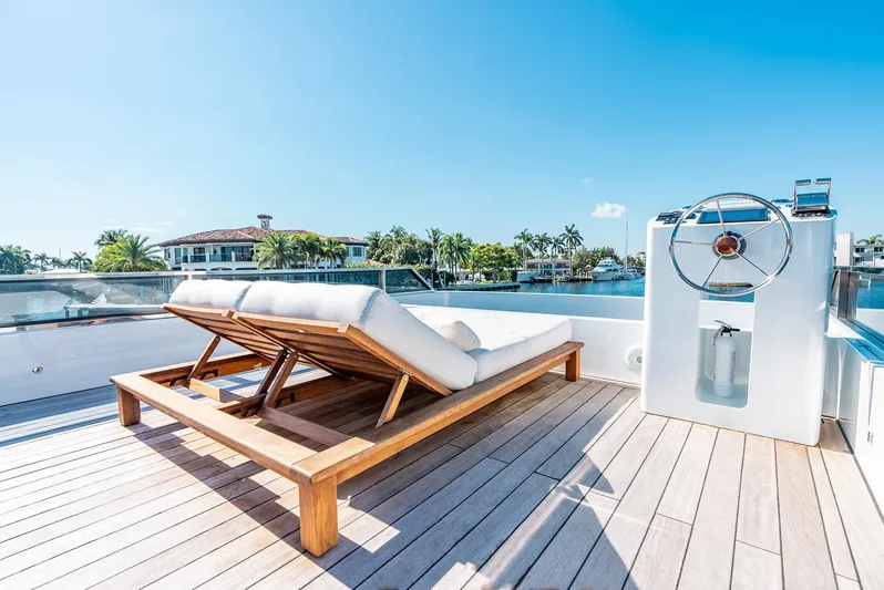  Yacht Photos Pics Luxurious Reina 44DR yacht deck with sun loungers and steering wheel, 2023 model.