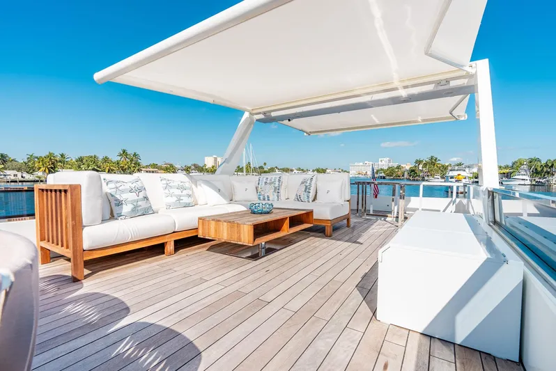  Yacht Photos Pics Luxurious Reina 44DR yacht deck with elegant seating and sunshade, 2023 model.