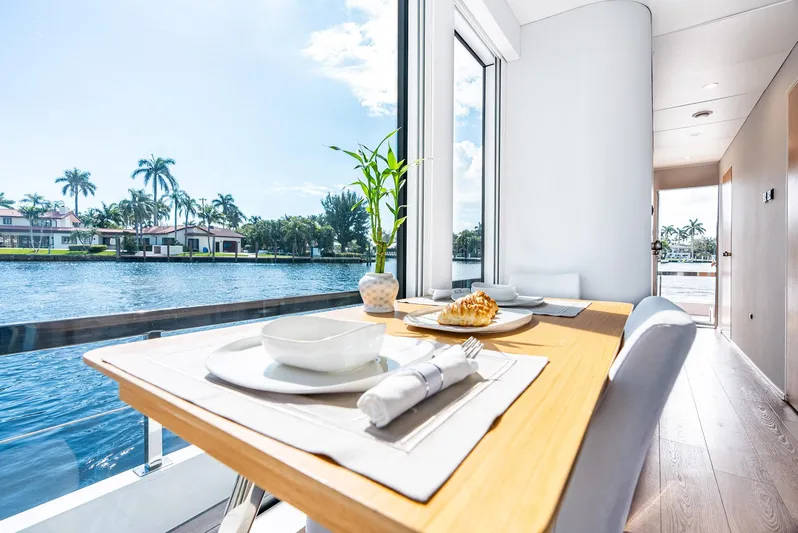  Yacht Photos Pics Modern dining area on Reina 44DR yacht, 2023, with waterfront view and elegant table setting.