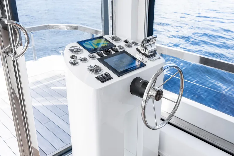  Yacht Photos Pics Helm of Reina 44DR yacht, featuring modern navigation controls, overlooking the ocean.