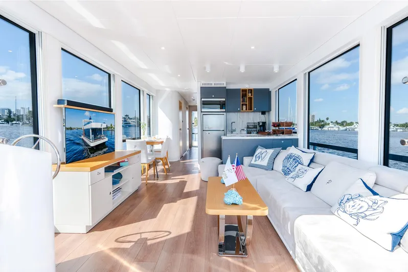  Yacht Photos Pics Modern 2023 Reina 44DR yacht interior with spacious living area, large windows, and elegant decor.