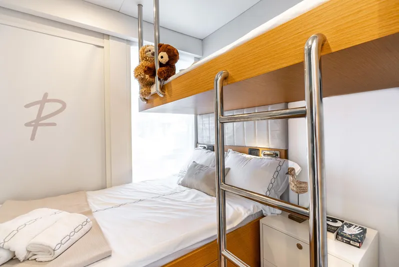  Yacht Photos Pics Modern Reina 44DR 2023 bunk bed with ladder, cozy bedding, and plush teddy bear.