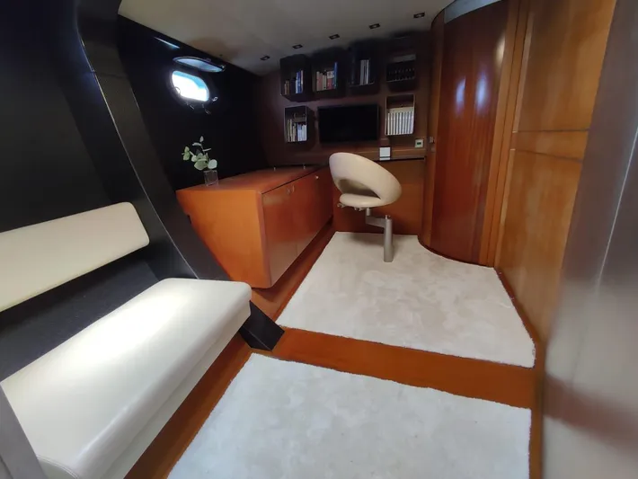  Yacht Photos Pics Luxurious yacht interior with wooden furnishings, white seating, and a modern workspace. CMN 139, 1994.