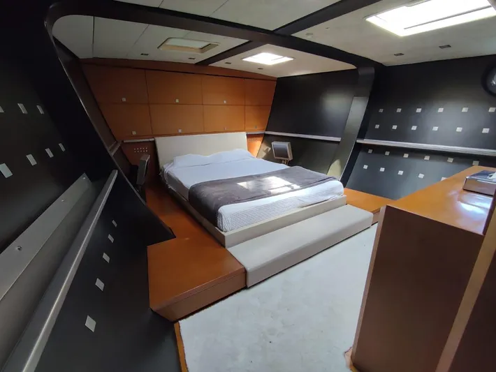  Yacht Photos Pics Modern bedroom with sleek design, featuring a bed and contemporary decor in a CMN 139 yacht.