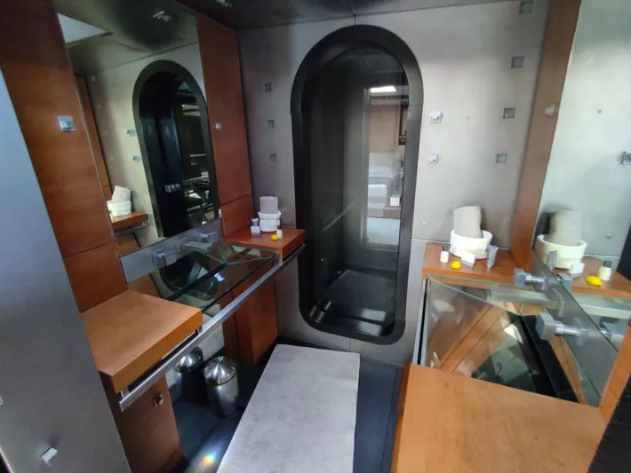  Yacht Photos Pics Modern bathroom with wood accents, glass surfaces, and a sleek shower in a CMN 139 yacht, 1994.