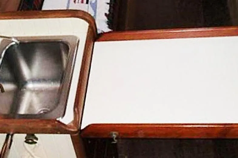 Jolie Brise Yacht Photos Pics Interior of 1985 Sam L. Morse Bristol Channel Cutter 28, featuring a compact sink and countertop.