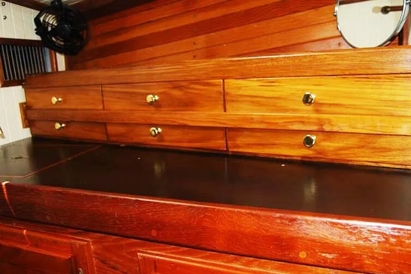 Jolie Brise Yacht Photos Pics Wooden interior of 1985 Sam L. Morse Bristol Channel Cutter 28 with drawers and brass knobs.