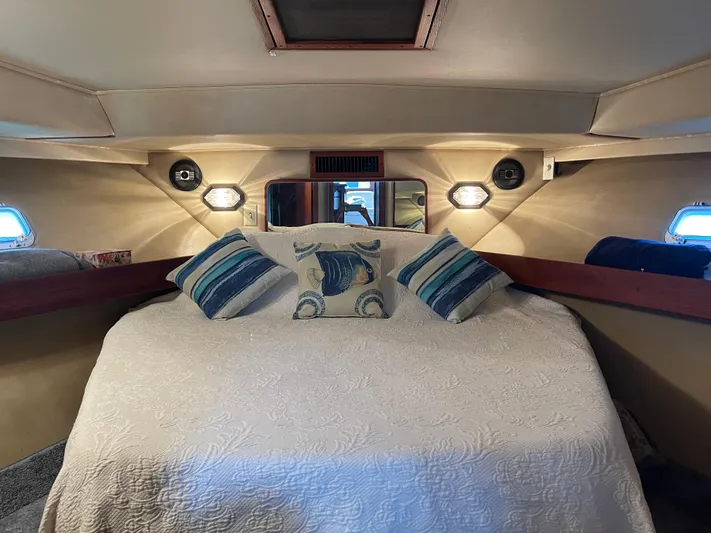 Kylieb Yacht Photos Pics Luxurious 1986 Chris-Craft 422 Commander cabin interior with cozy bedding and nautical decor.