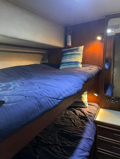 Kylieb Yacht Photos Pics 1986 Chris-Craft 422 Commander cabin with bunk beds and blue bedding.
