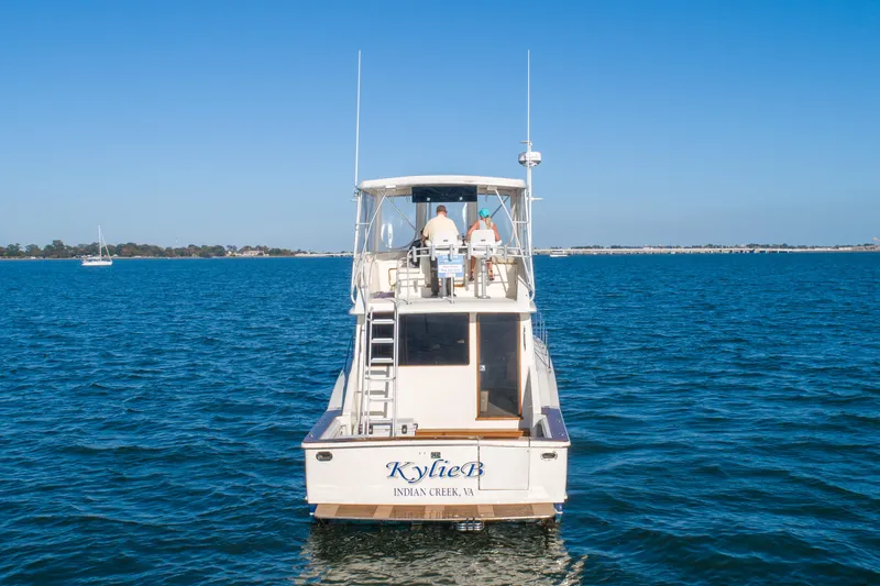 Kylieb Yacht Photos Pics 1986 Chris-Craft 422 Commander yacht on open water, rear view.