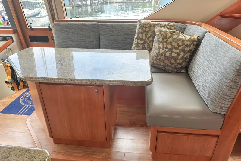 "mi Alma" Yacht Photos Pics 2004 West Bay Sonship yacht interior with cushioned seating and granite table.