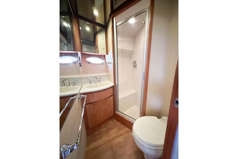 "mi Alma" Yacht Photos Pics Luxurious bathroom in 2004 West Bay Sonship yacht with shower, sink, and toilet.