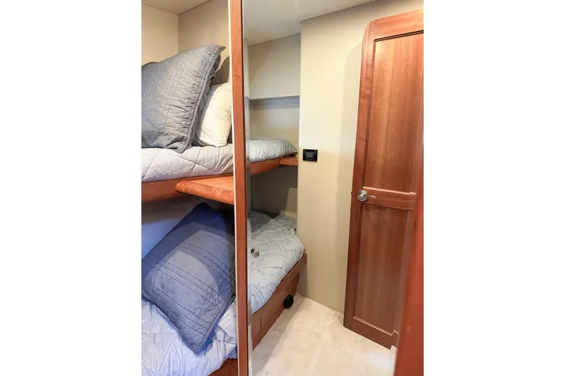 "mi Alma" Yacht Photos Pics Cozy bunk beds in 2004 West Bay Sonship yacht cabin with wooden door.