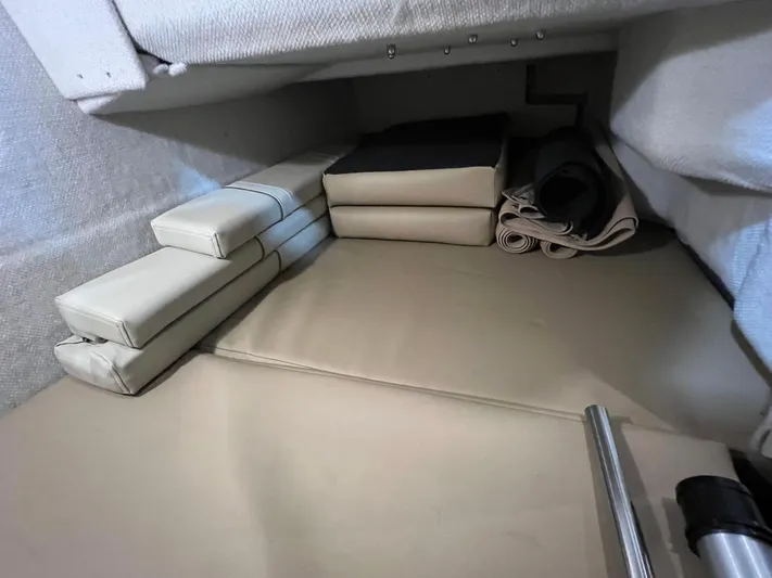 Regulus Yacht Photos Pics 2023 Ranger Tugs R-25 interior cabin with beige cushions and storage space.