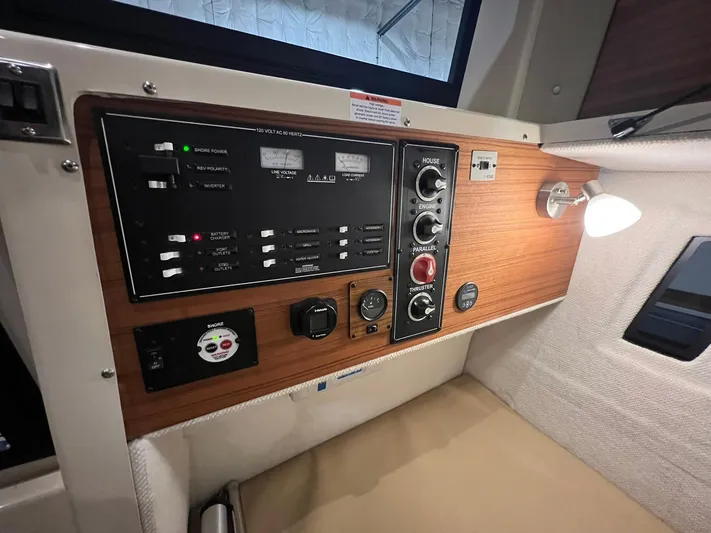 Regulus Yacht Photos Pics Control panel of 2023 Ranger Tugs R-25 boat with wood finish and modern switches.