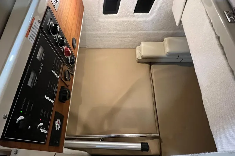 Regulus Yacht Photos Pics 2023 Ranger Tugs R-25 interior cabin with control panel and seating area.