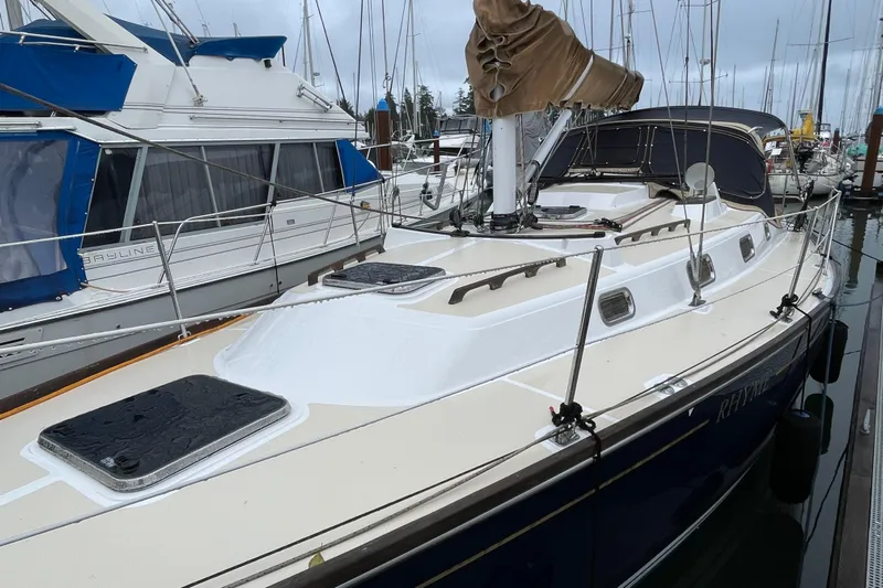 Rhyme Yacht Photos Pics Sailboat docked in marina, Tartan 3400 model, 2007, with covered mast and sleek design.