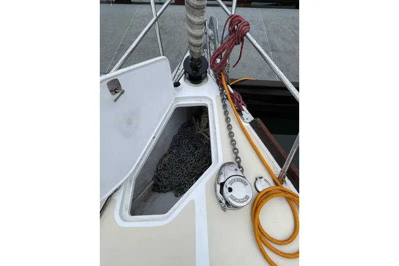 Rhyme Yacht Photos Pics Open anchor locker on 2007 Tartan 3400 sailboat with chain and ropes visible.