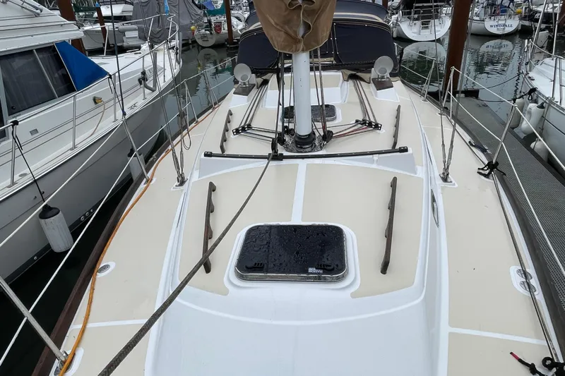 Rhyme Yacht Photos Pics 2007 Tartan 3400 sailboat deck view in marina, surrounded by other boats.