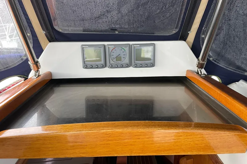Rhyme Yacht Photos Pics Cockpit of 2007 Tartan 3400 sailboat with navigation instruments and wooden trim.