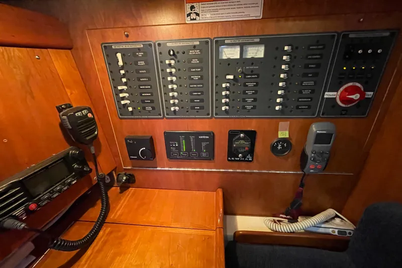 Rhyme Yacht Photos Pics Electrical control panel inside a 2007 Tartan 3400 yacht, featuring switches and communication devices.