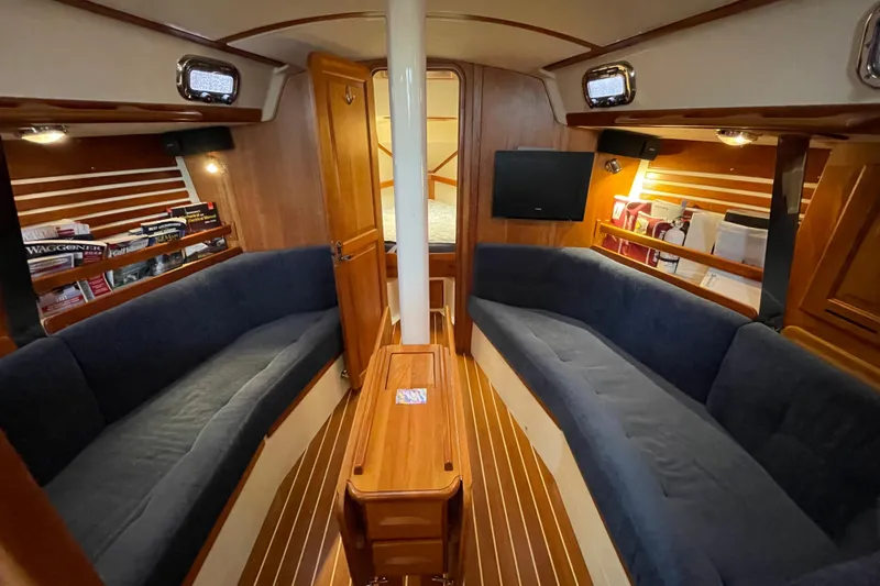 Rhyme Yacht Photos Pics Interior of 2007 Tartan 3400 sailboat with cozy seating and wooden finishes.