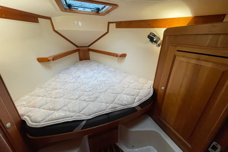 Rhyme Yacht Photos Pics Cozy cabin interior of 2007 Tartan 3400 sailboat with a comfortable bed.