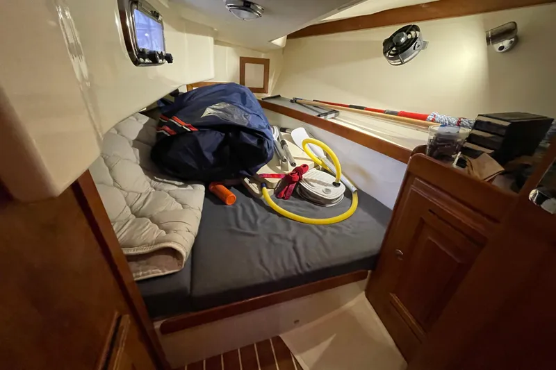 Rhyme Yacht Photos Pics Cozy cabin interior of 2007 Tartan 3400 sailboat with storage and equipment.