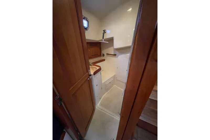 Rhyme Yacht Photos Pics 2007 Tartan 3400 yacht interior bathroom with wooden cabinetry and compact design.