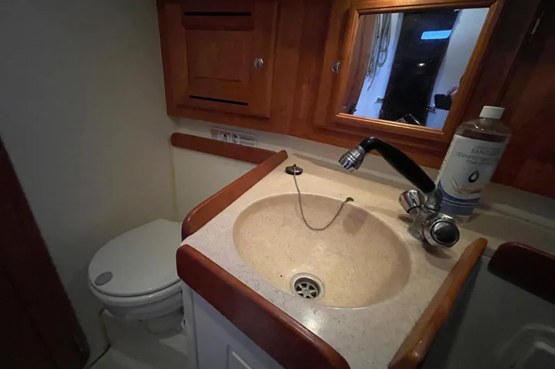 Rhyme Yacht Photos Pics Compact bathroom in 2007 Tartan 3400 yacht with sink, mirror, and toilet.
