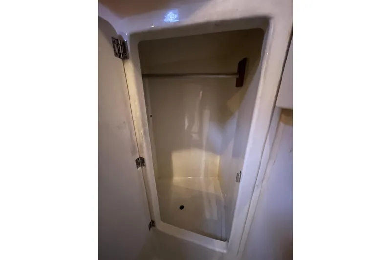 Rhyme Yacht Photos Pics Empty storage compartment inside 2007 Tartan 3400 boat, featuring a hanging rod.