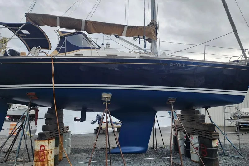 Rhyme Yacht Photos Pics Sailboat Tartan 3400, 2007 model, elevated on supports in a boatyard.