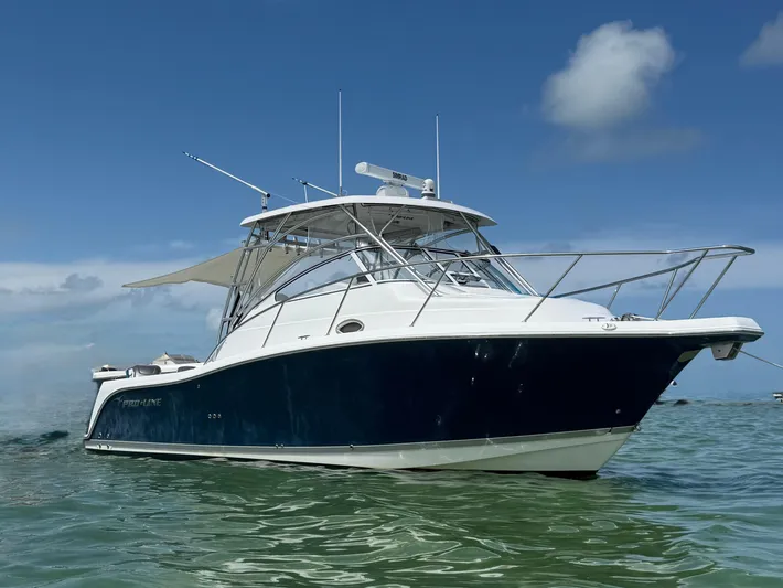 Sea Stress Yacht Photos Pics 2008 Pro-Line 32 Express boat on calm water under clear blue sky.