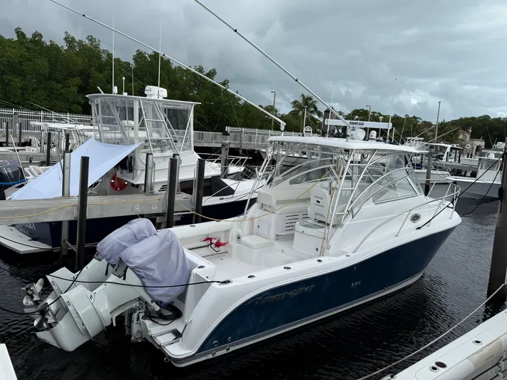Sea Stress Yacht Photos Pics 2008 Pro-Line 32 Express boat docked at marina, featuring sleek design and dual outboard engines.