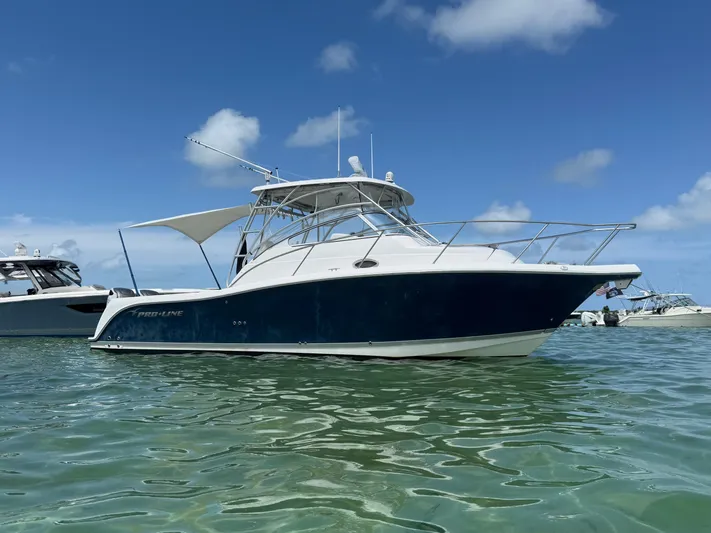 Sea Stress Yacht Photos Pics 2008 Pro-Line 32 Express boat on clear water under blue sky.