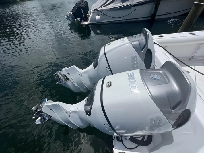 Sea Stress Yacht Photos Pics Twin Suzuki 300 outboard engines on a 2008 Pro-Line 32 Express boat, docked in water.